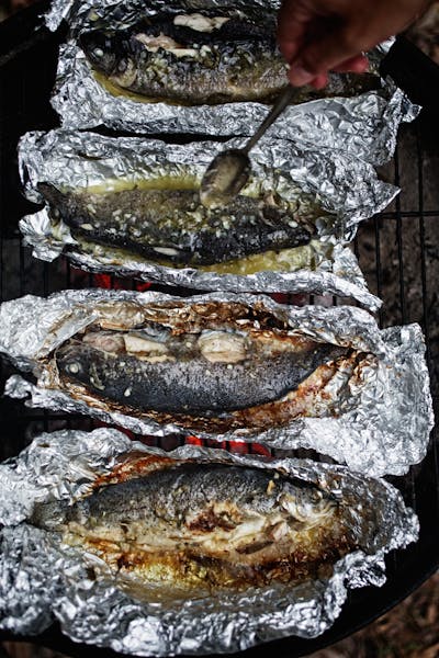 Charlie Palmer Restaurant Consulting's cooked trout in foil with sage butter