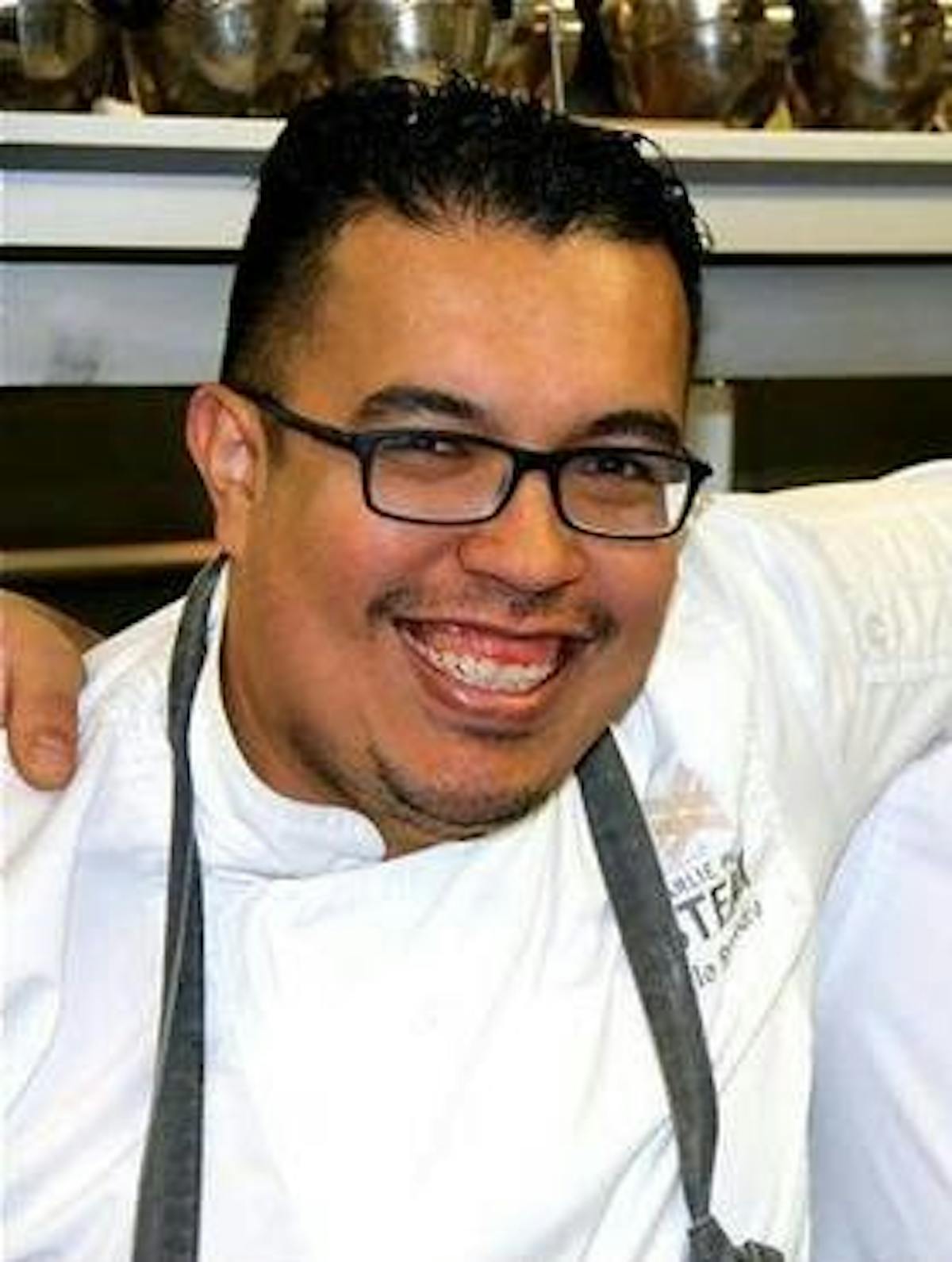 a man in glasses looking at the camera