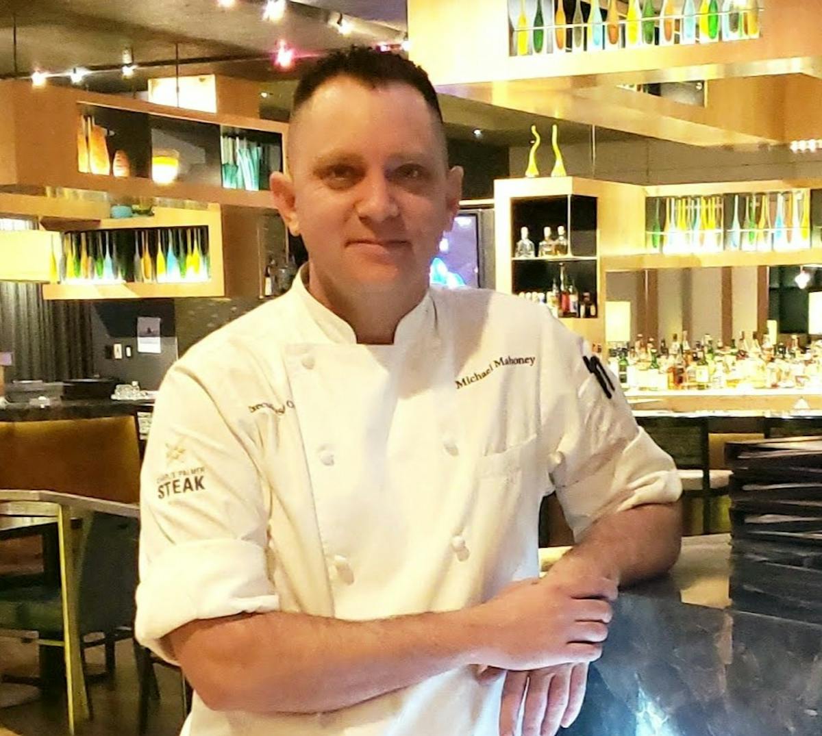 a man standing in a kitchen preparing food