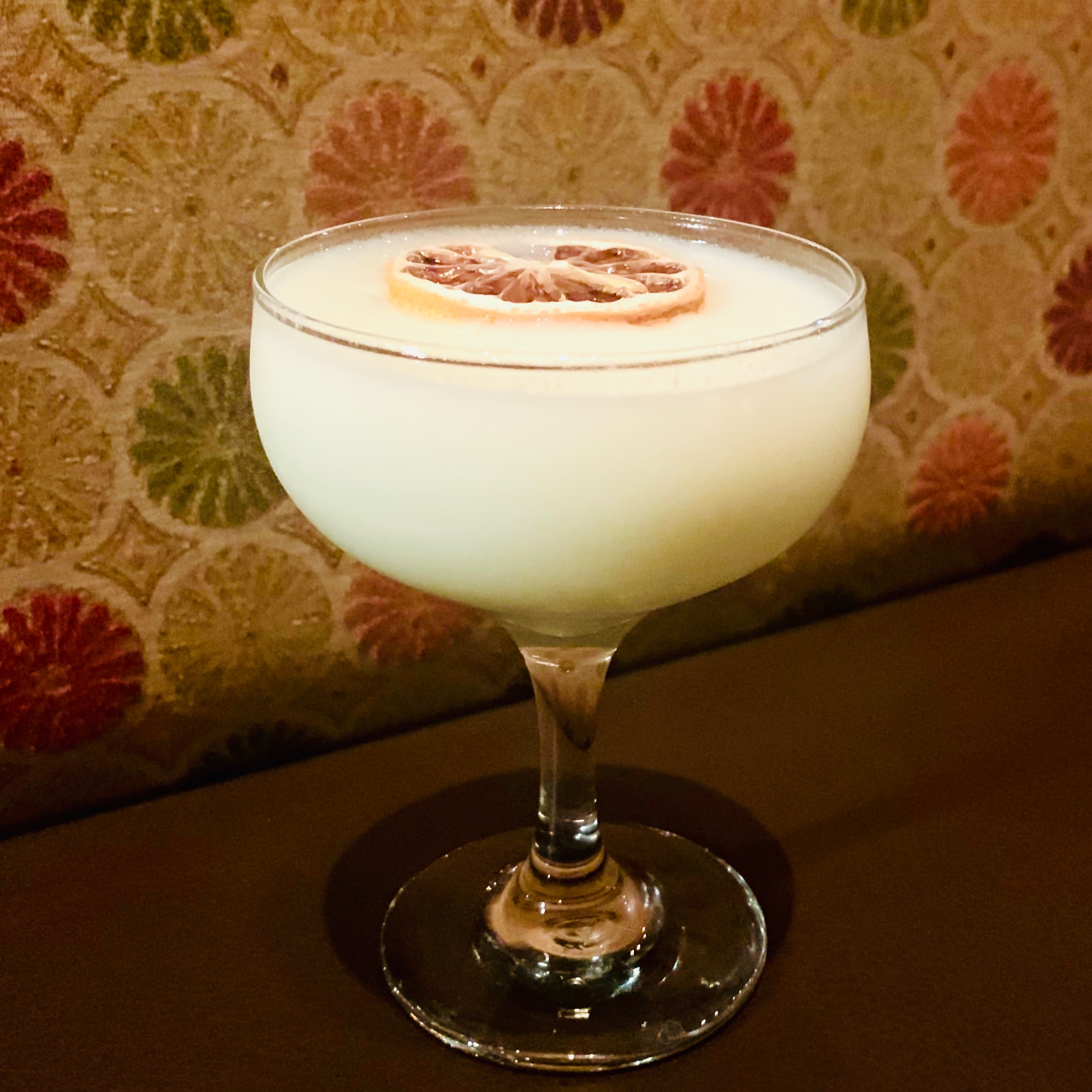 a glass of wine on a table