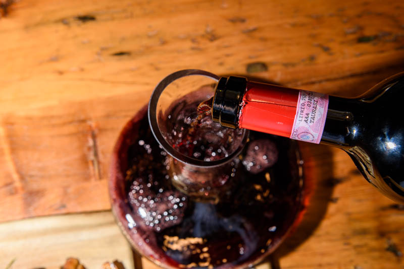 a bottle of wine sitting on top of a wooden table