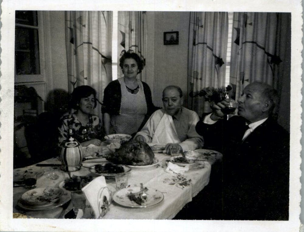 a group of people sitting at a table eating food