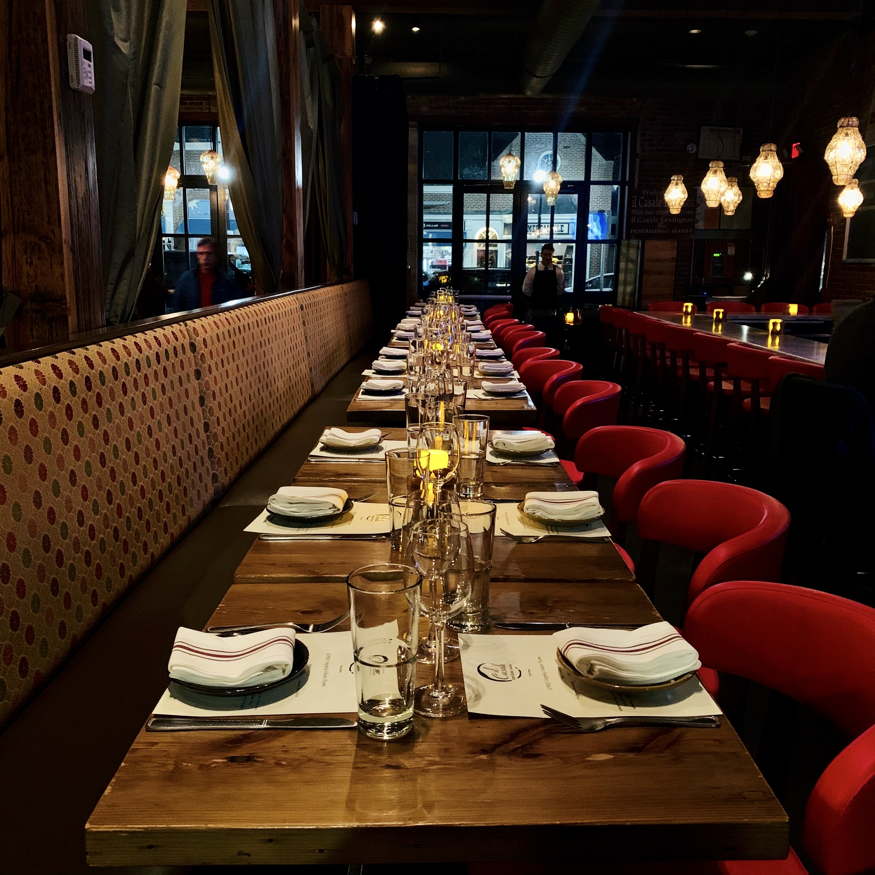 a row of wine glasses sitting on top of a wooden table