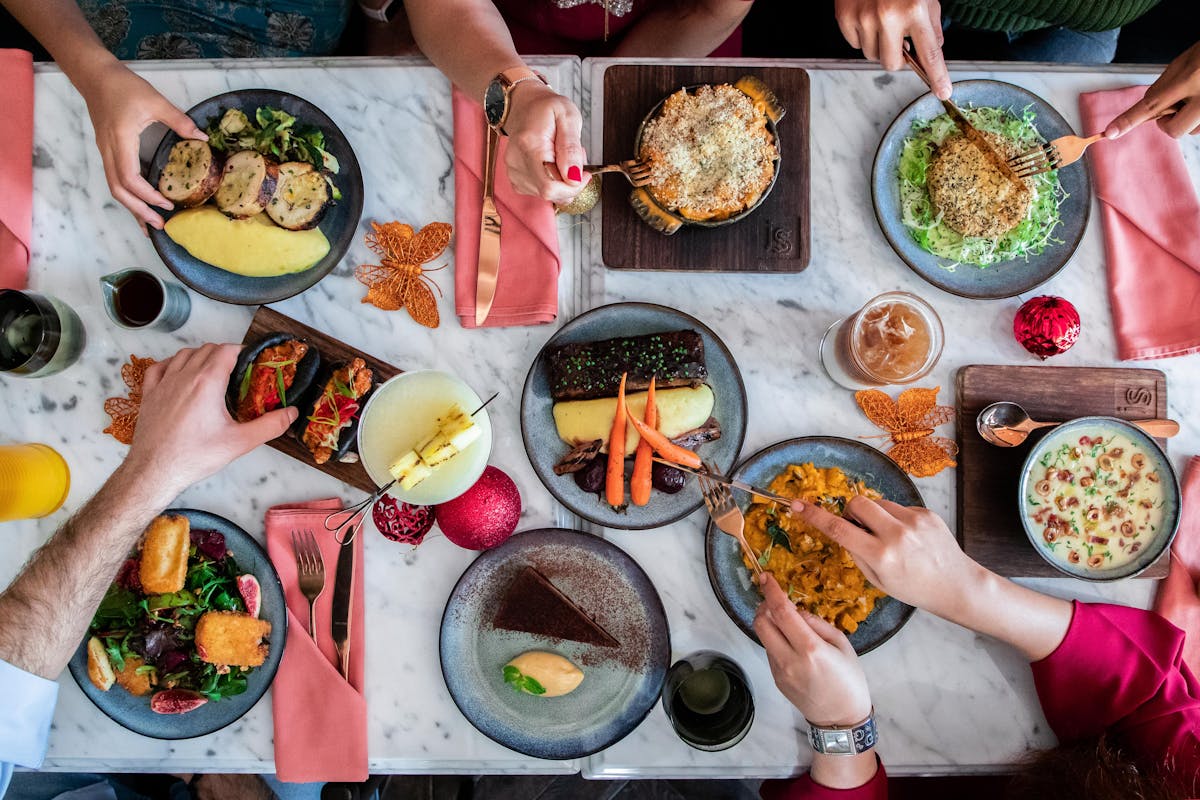 a group of people sitting at a table with a plate of food