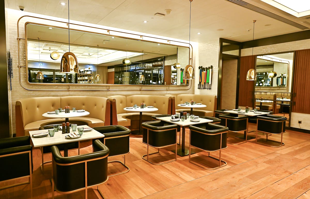 our modern dining area with a large wall mirror and dropped lights
