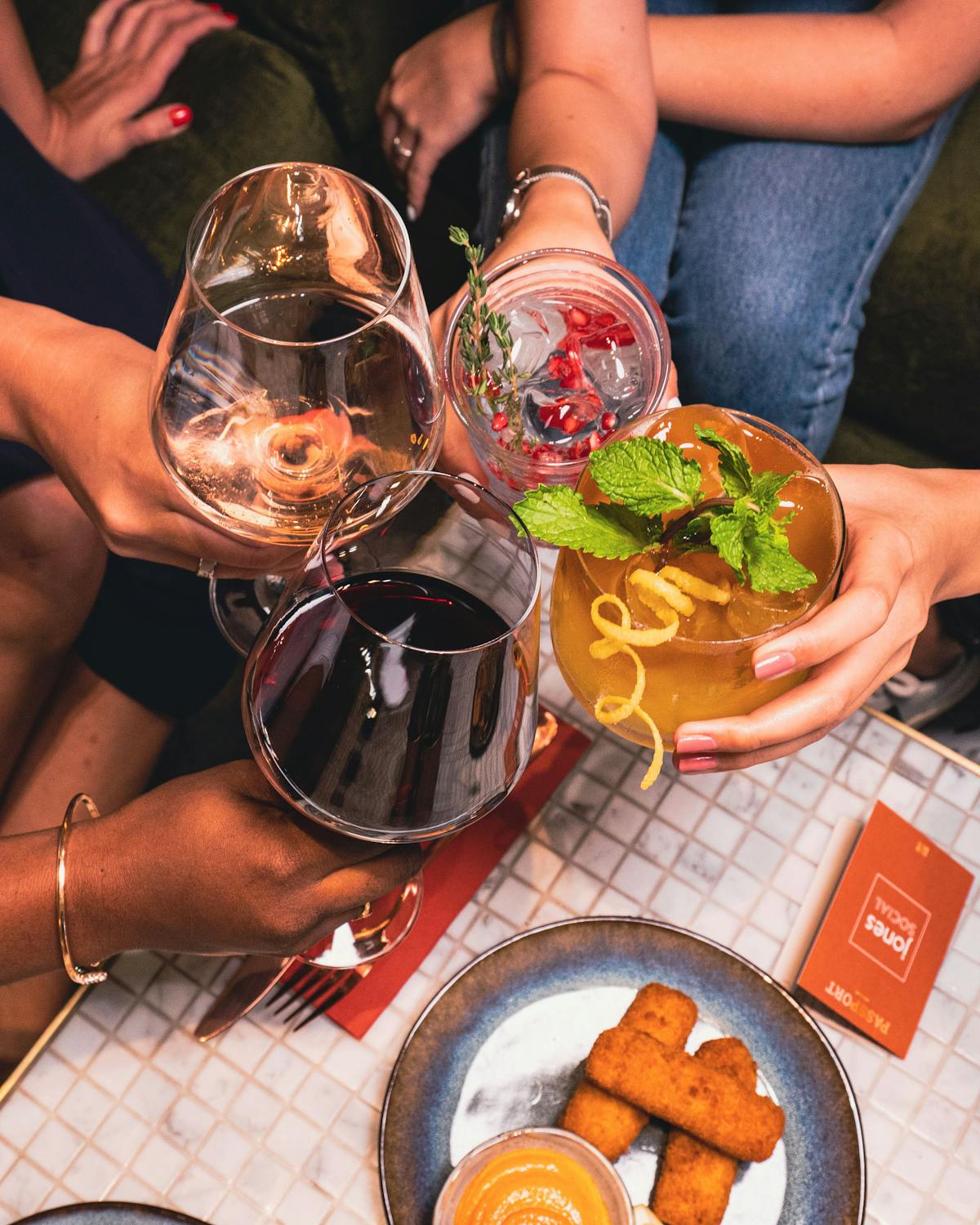 a woman sitting at a table with wine glasses