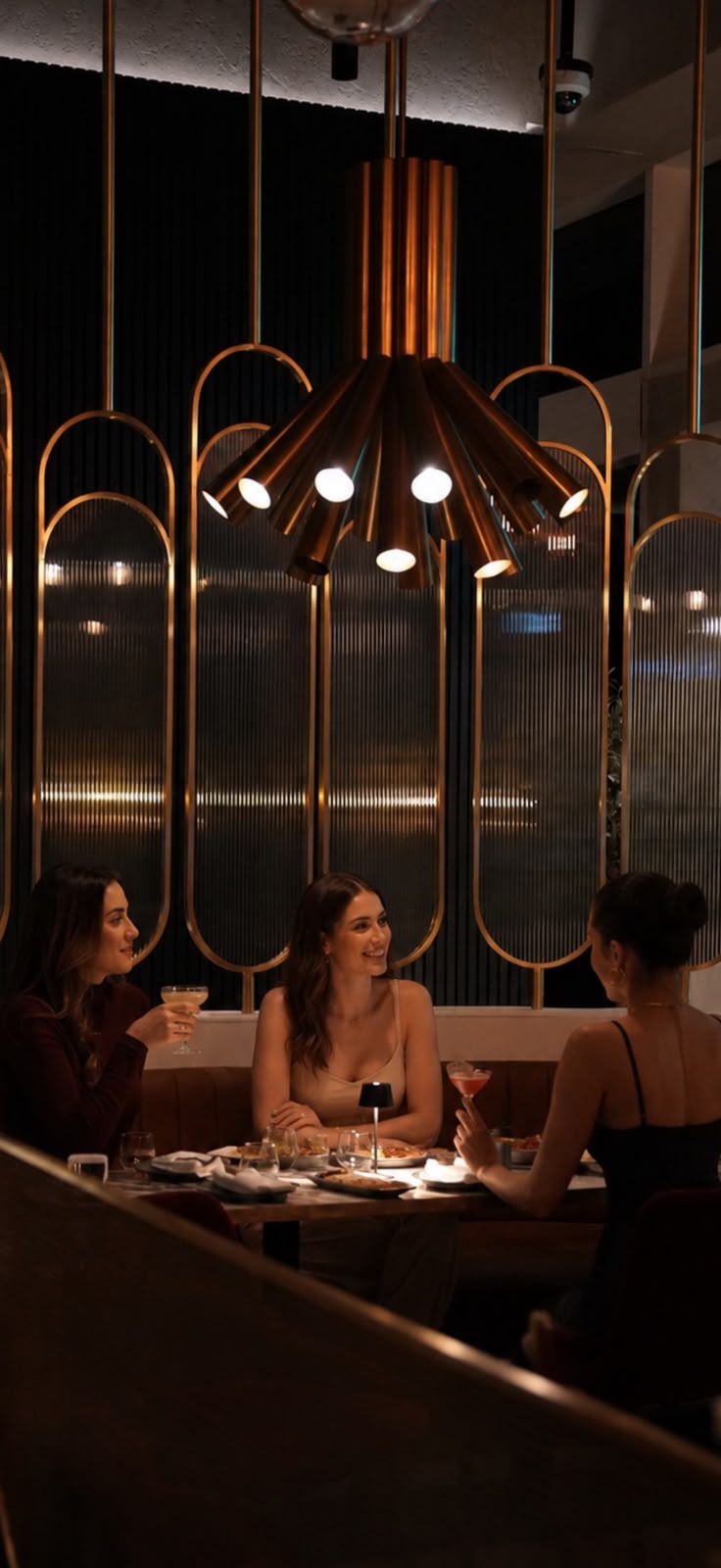 a group of women sitting at a table with drinks
