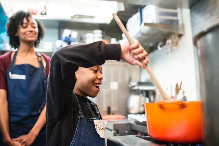 a person standing in a kitchen preparing food
