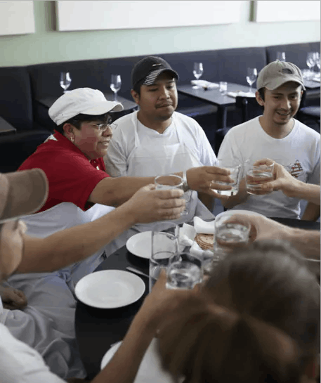 a group of people preparing food in a kitchen