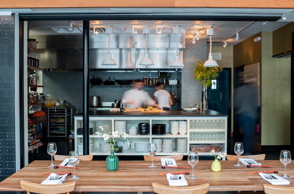 a kitchen with a table and a television