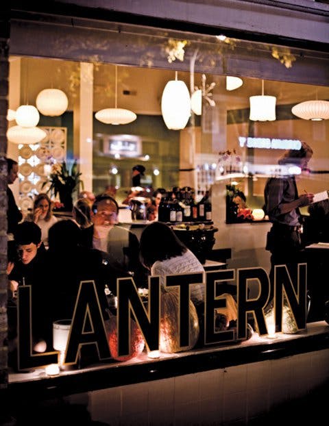 a group of people sitting at a table in a restaurant