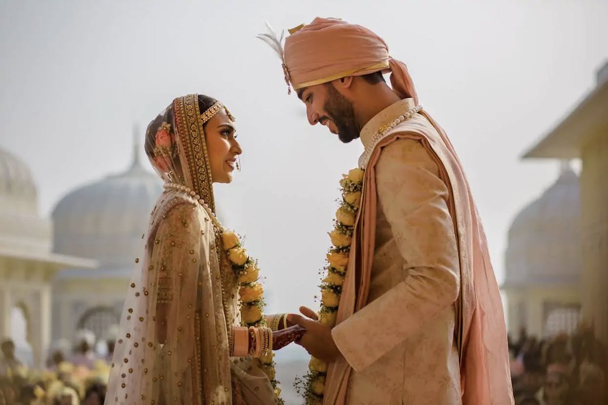 a man and a woman looking at the camera