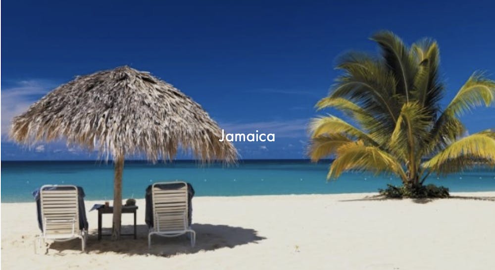 a group of lawn chairs sitting on top of a sandy beach