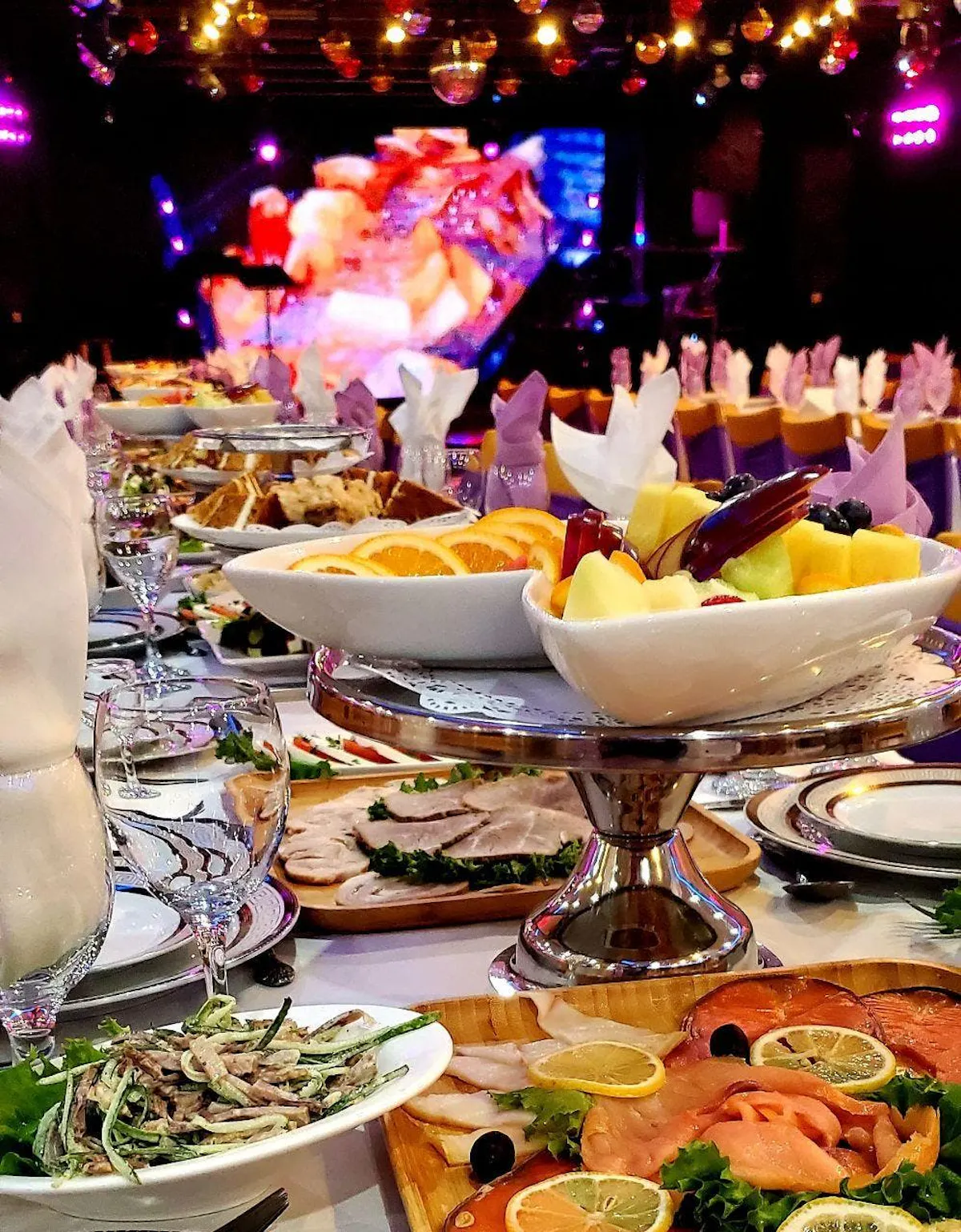 a group of people sitting at a table with a plate of food