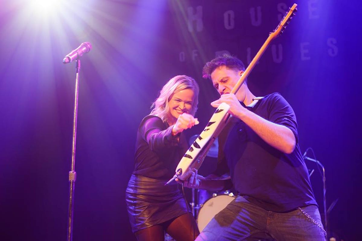 a person holding a baseball bat on a stage