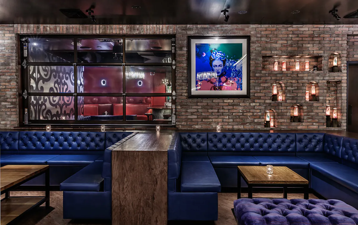 a room with two blue dining booths