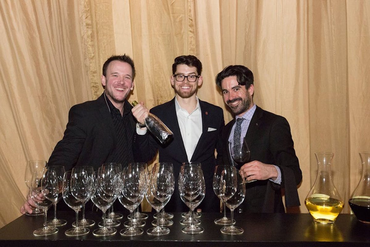a couple of people sitting at a table with wine glasses