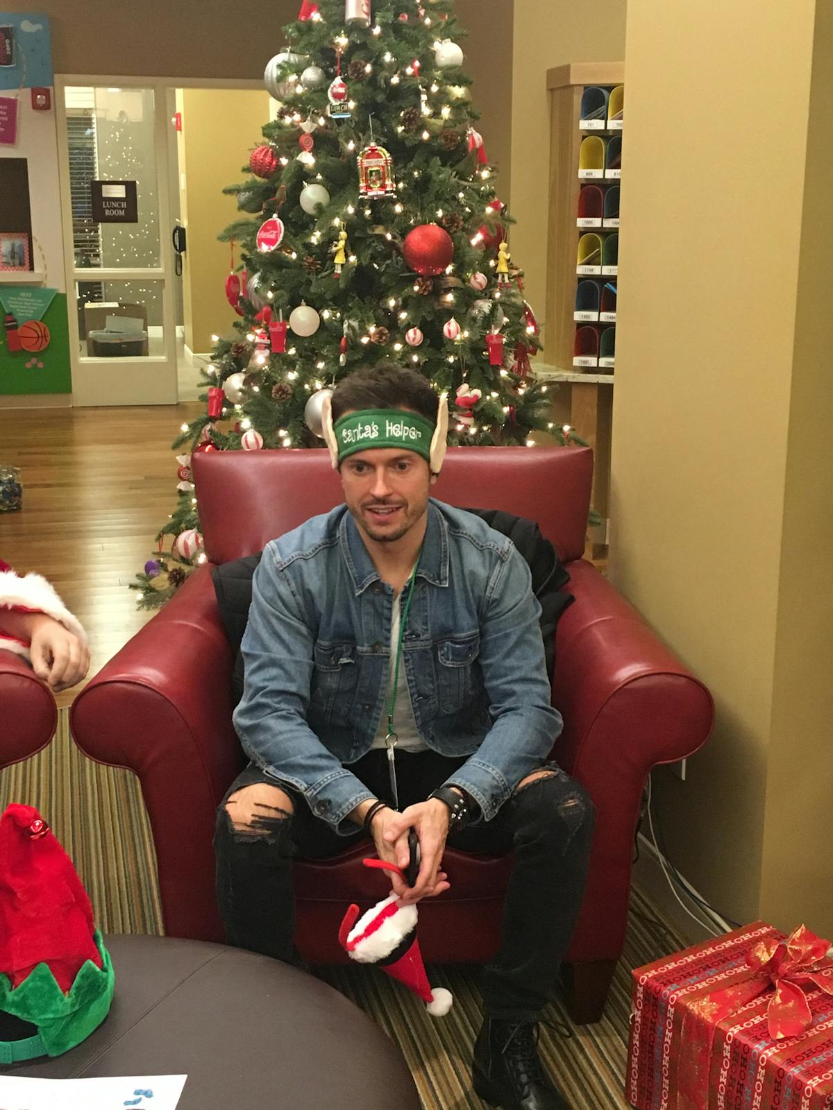 a person sitting on a red leather couch in a living room