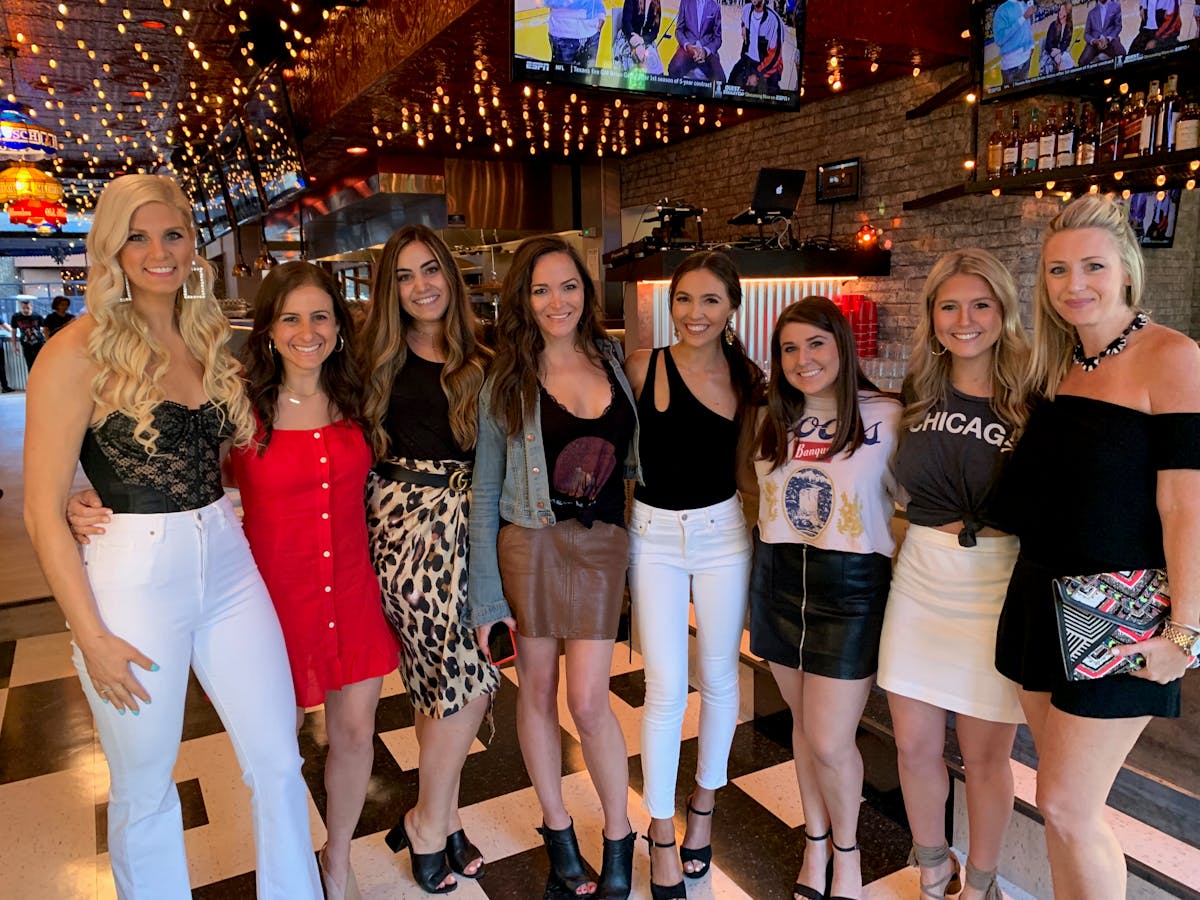 Cara Zizzo et al. standing in front of a crowd posing for the camera