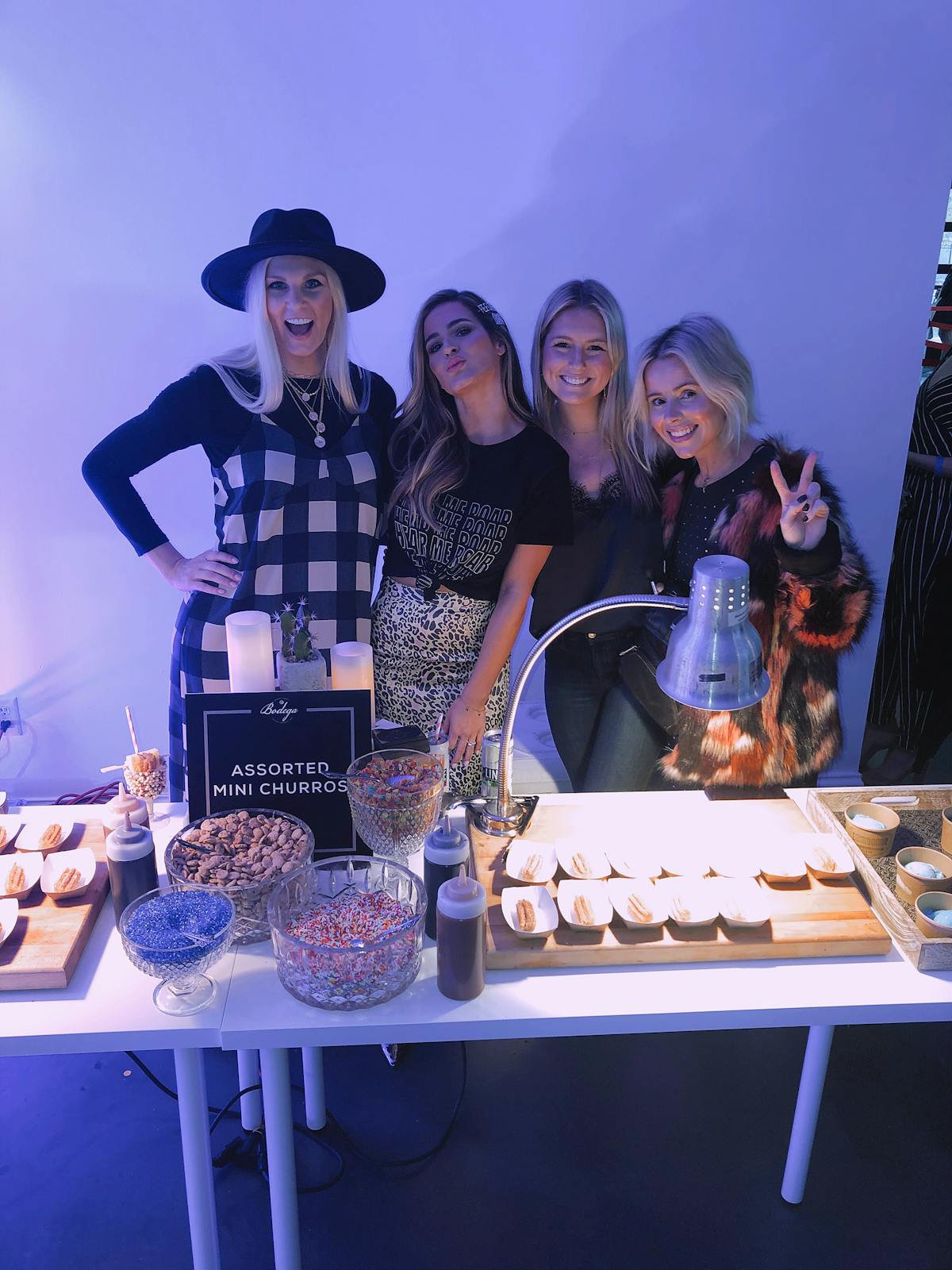 a group of people sitting at a table with a birthday cake