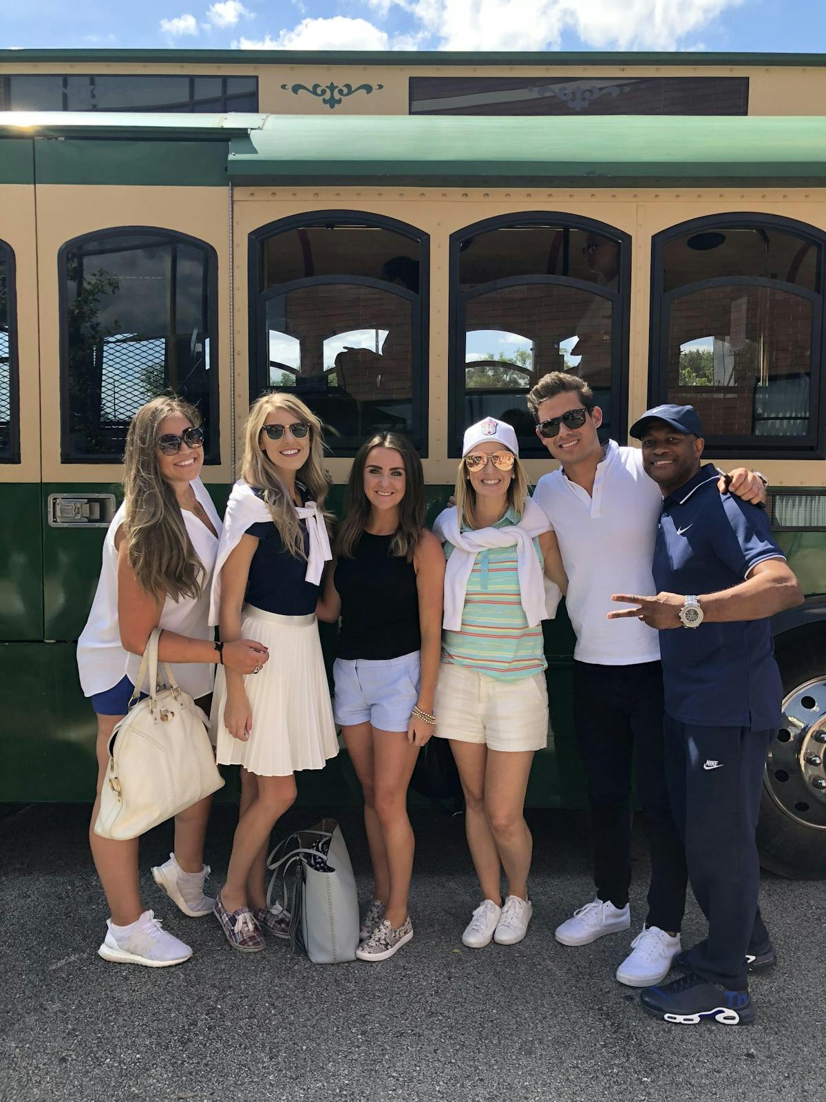 Chandra Knudsen et al. standing in front of a bus