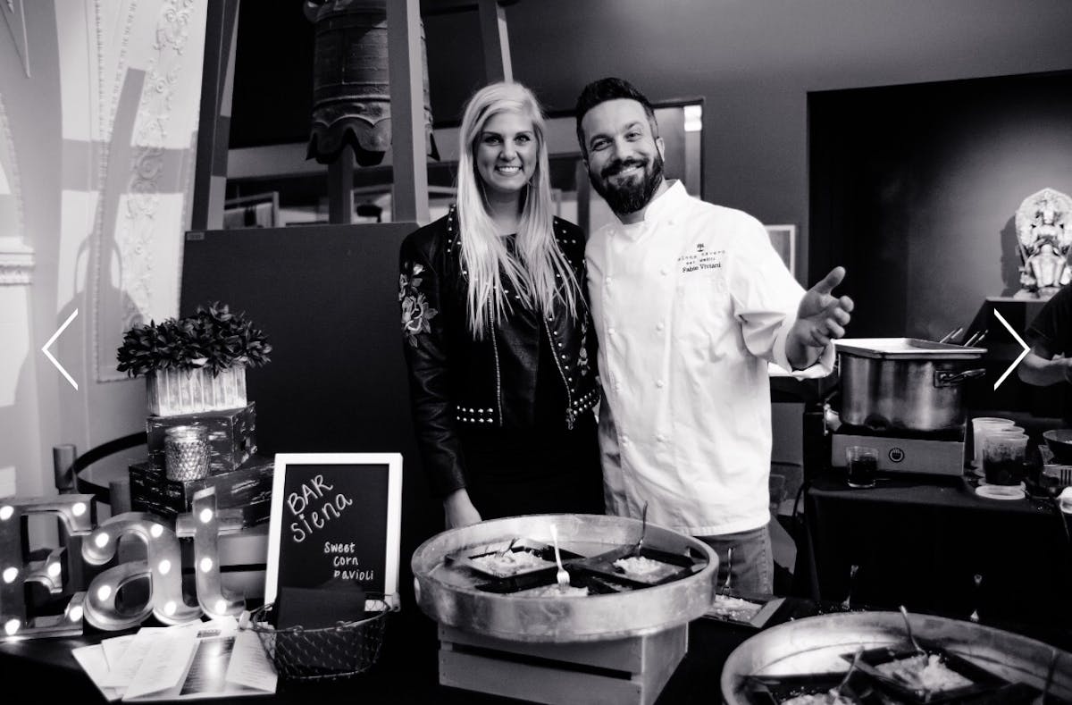 Fabio Viviani et al. standing in front of a table