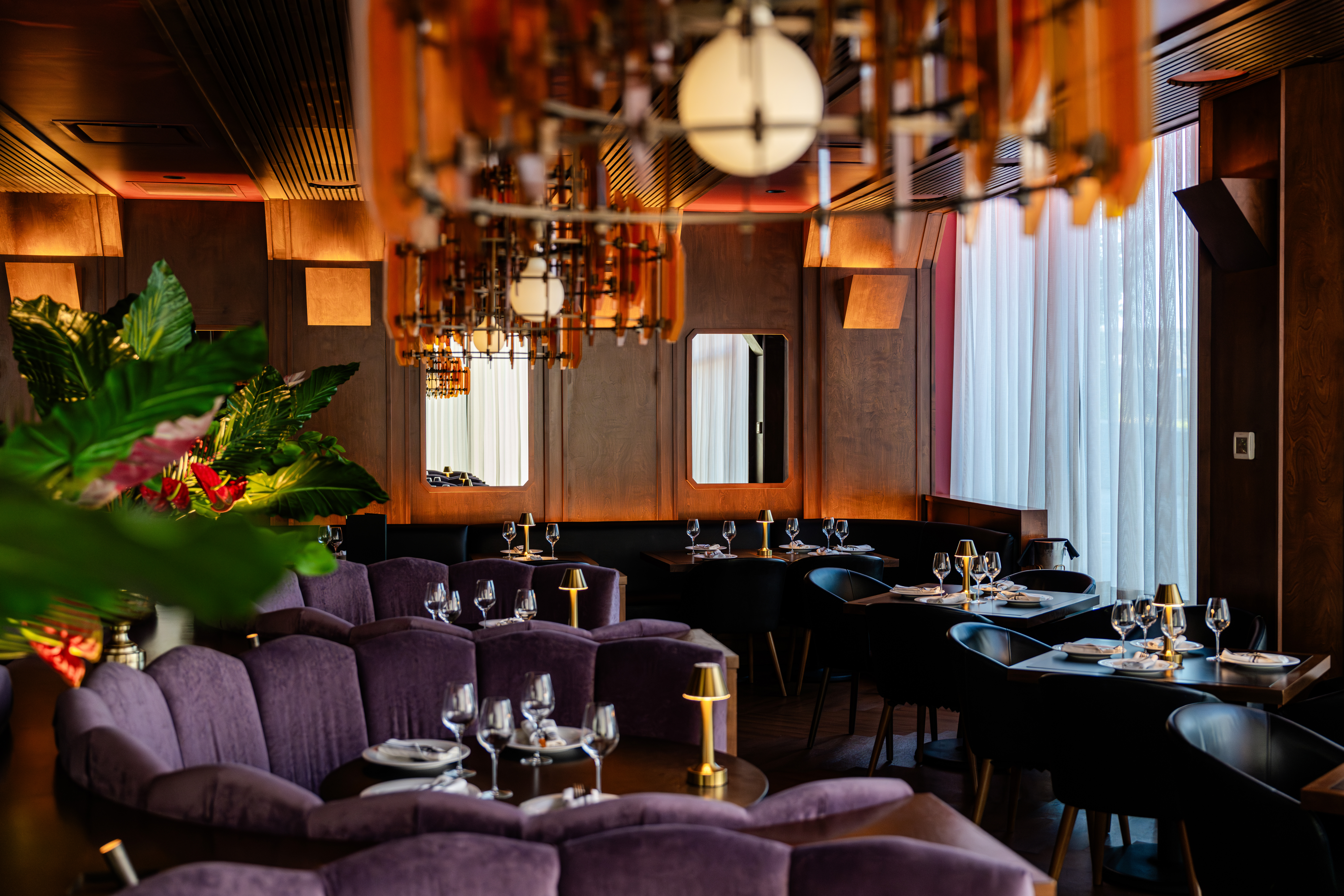 a room filled with furniture and vase of flowers on a table