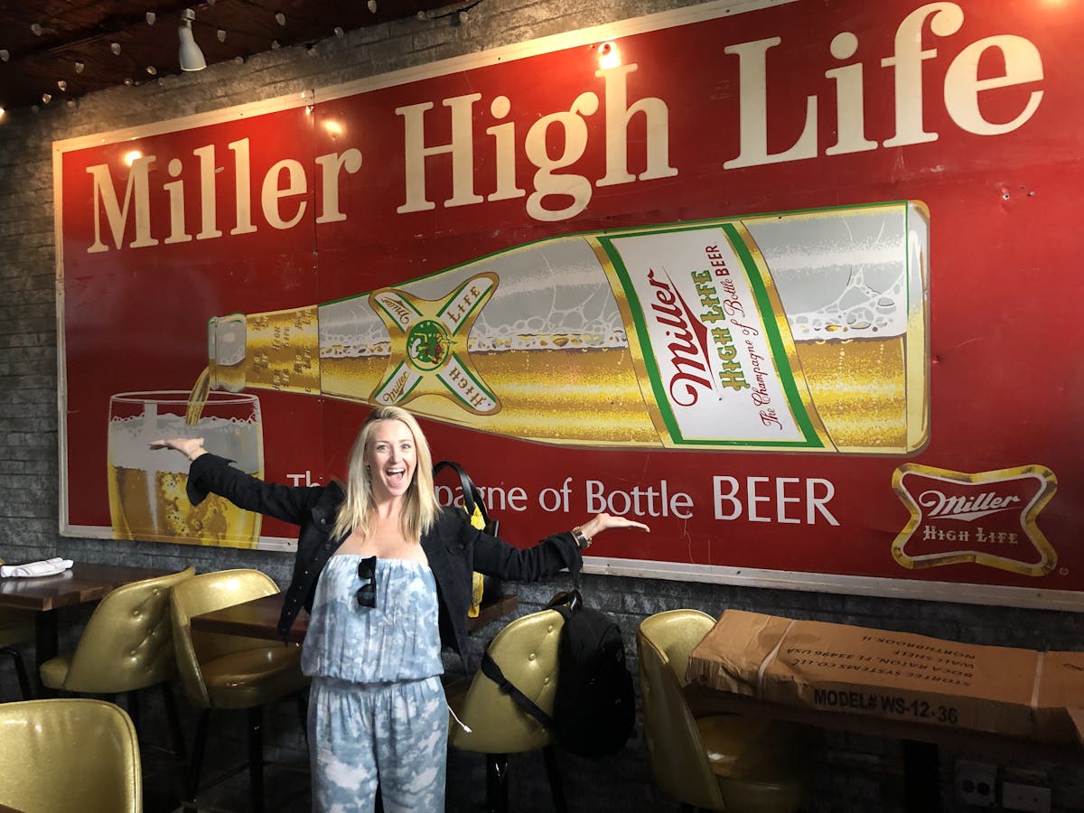 a person standing in front of a sign