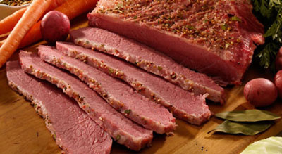 a cut in half sandwich sitting on top of a wooden cutting board