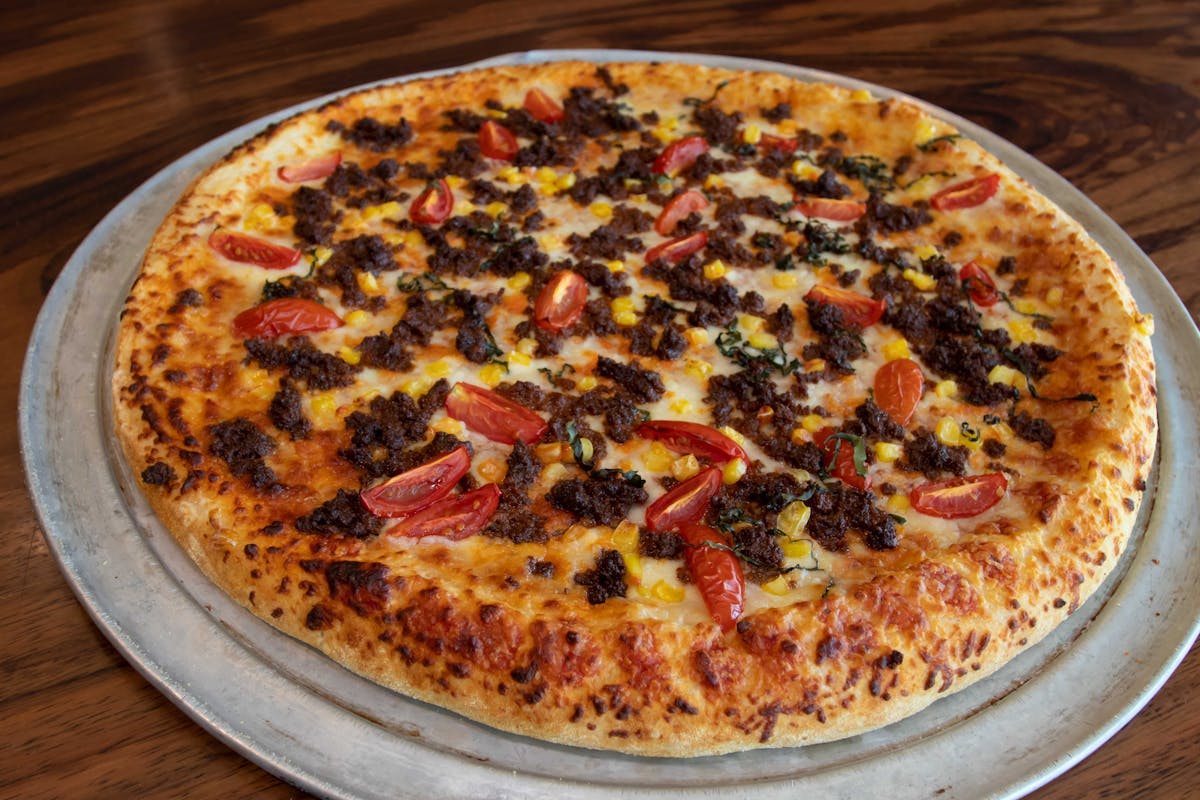 a pizza sitting on top of a wooden table