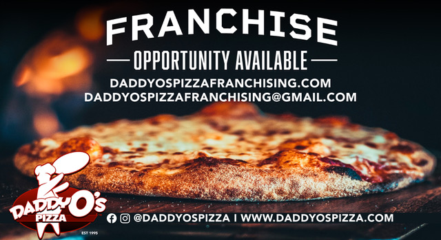 a pizza sitting on top of a book