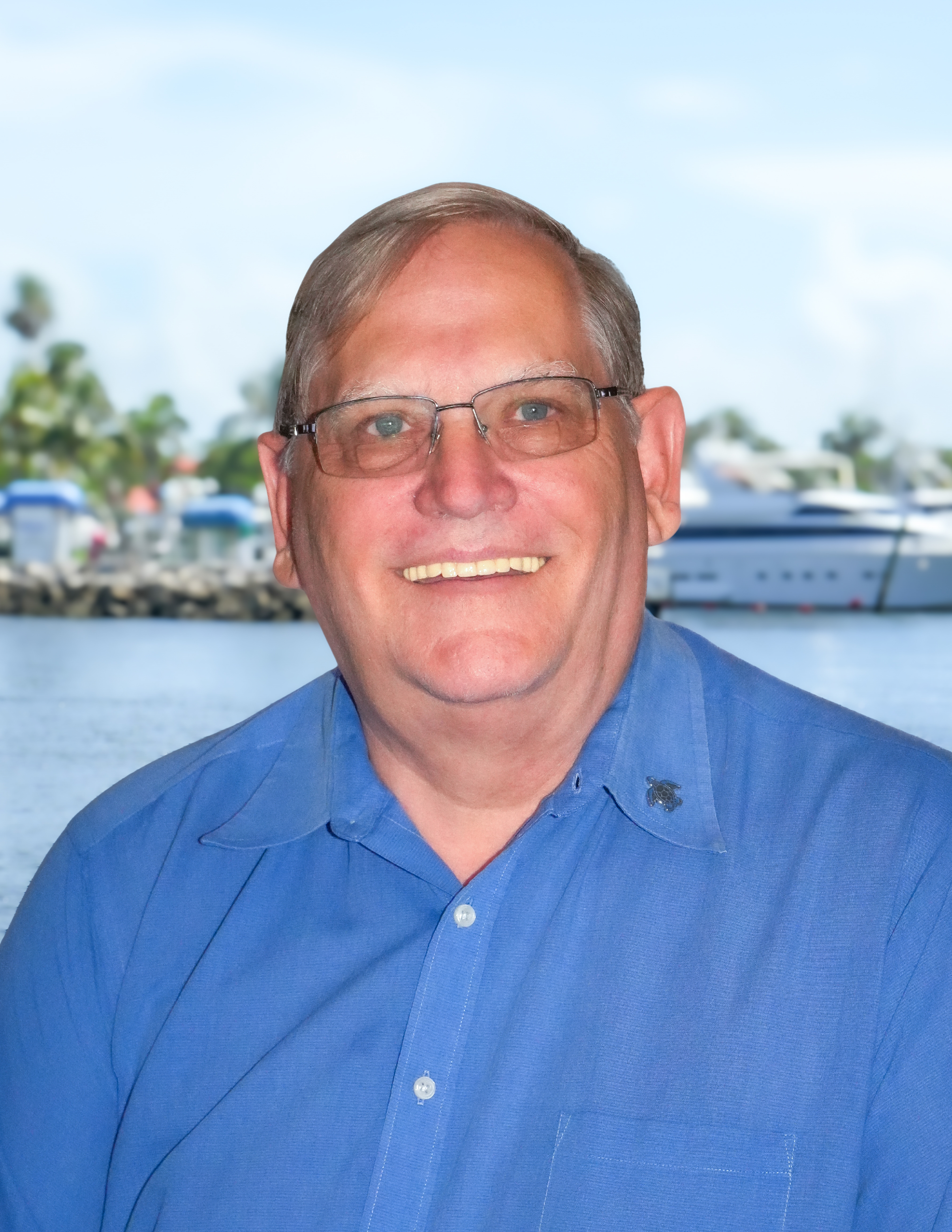 a man wearing glasses and a blue shirt