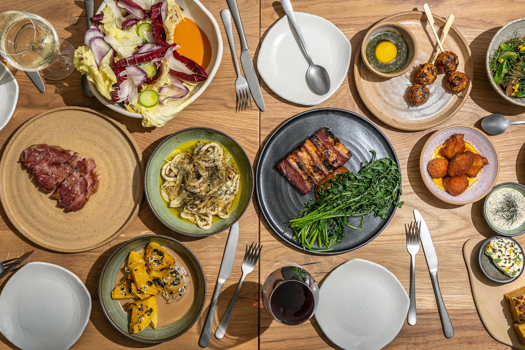 a bunch of food sitting on top of a wooden table