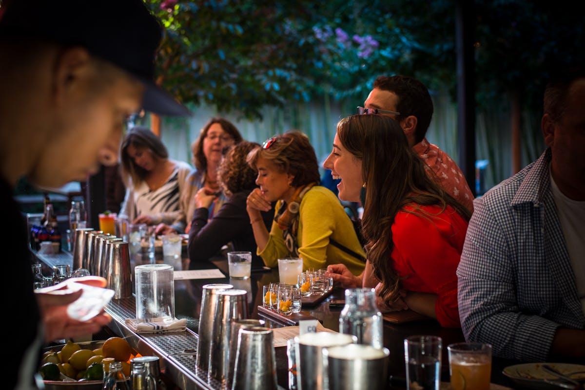 a group of people sitting at a table in a restaurant