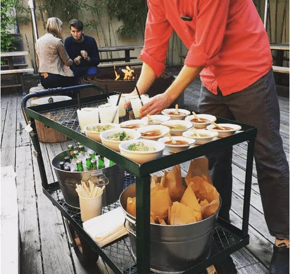 a group of people preparing food on a table