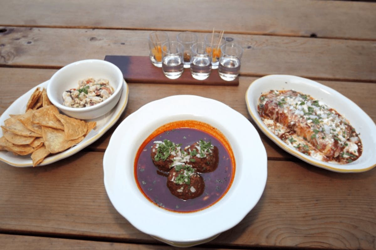 a plate of food sitting on top of a wooden table