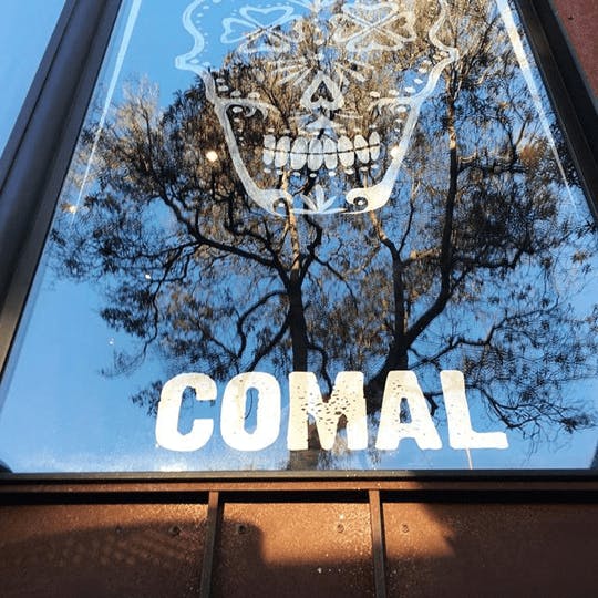 a close up of a sign in front of a window