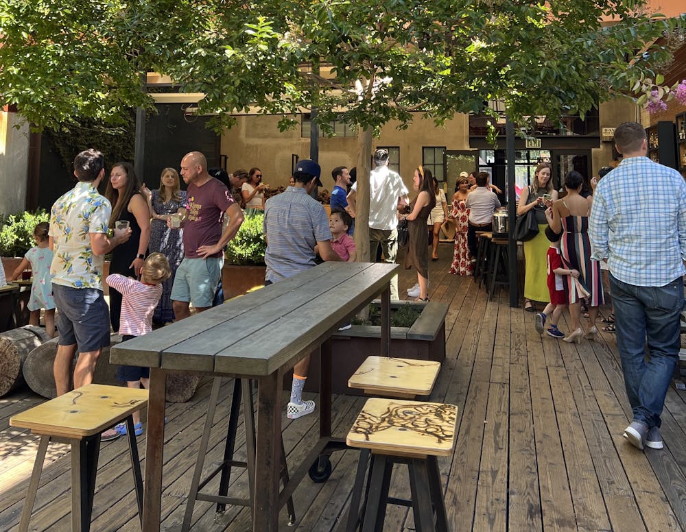 a group of people standing around a table