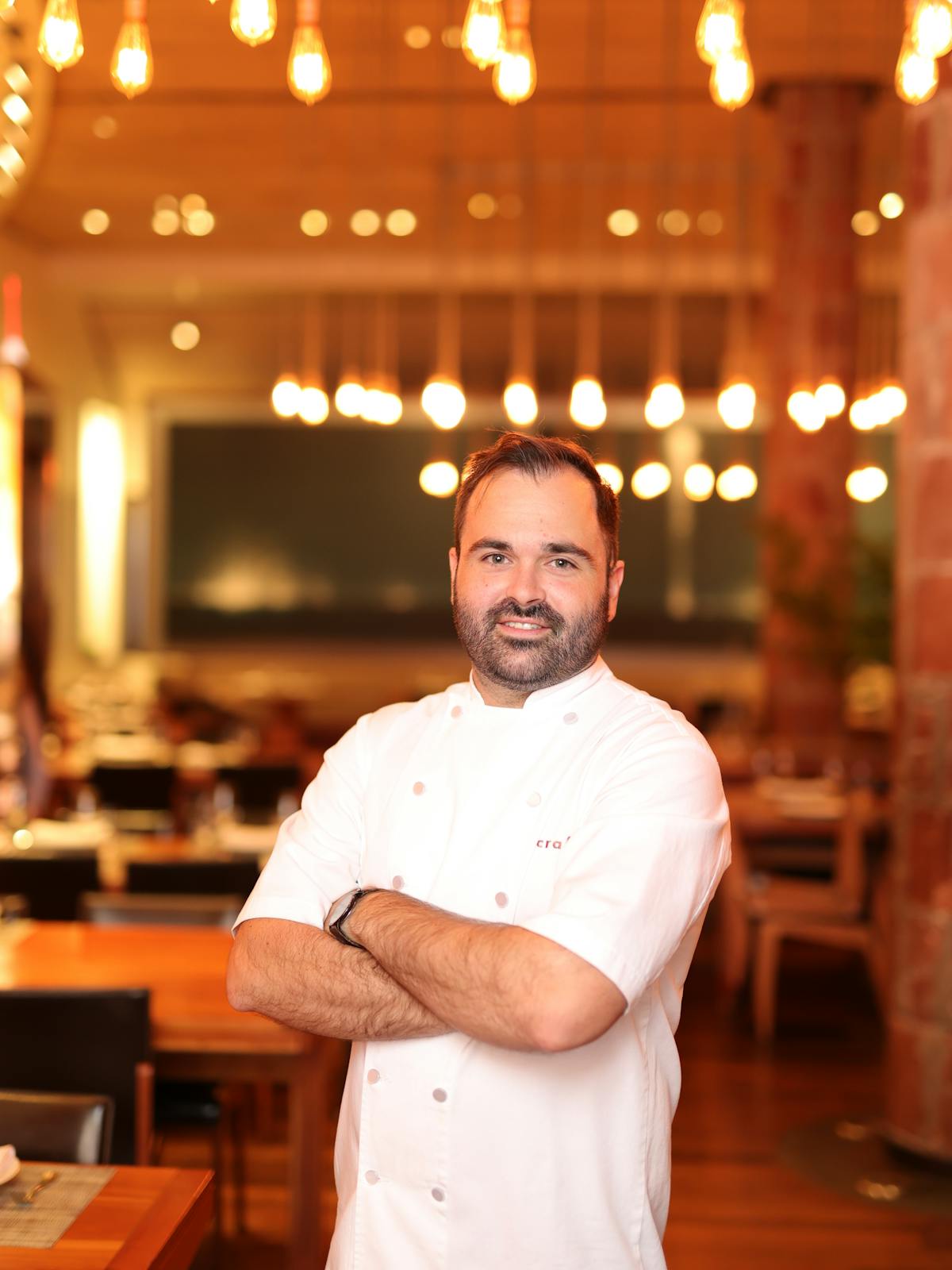 Evgeny Lebedev standing in front of a restaurant