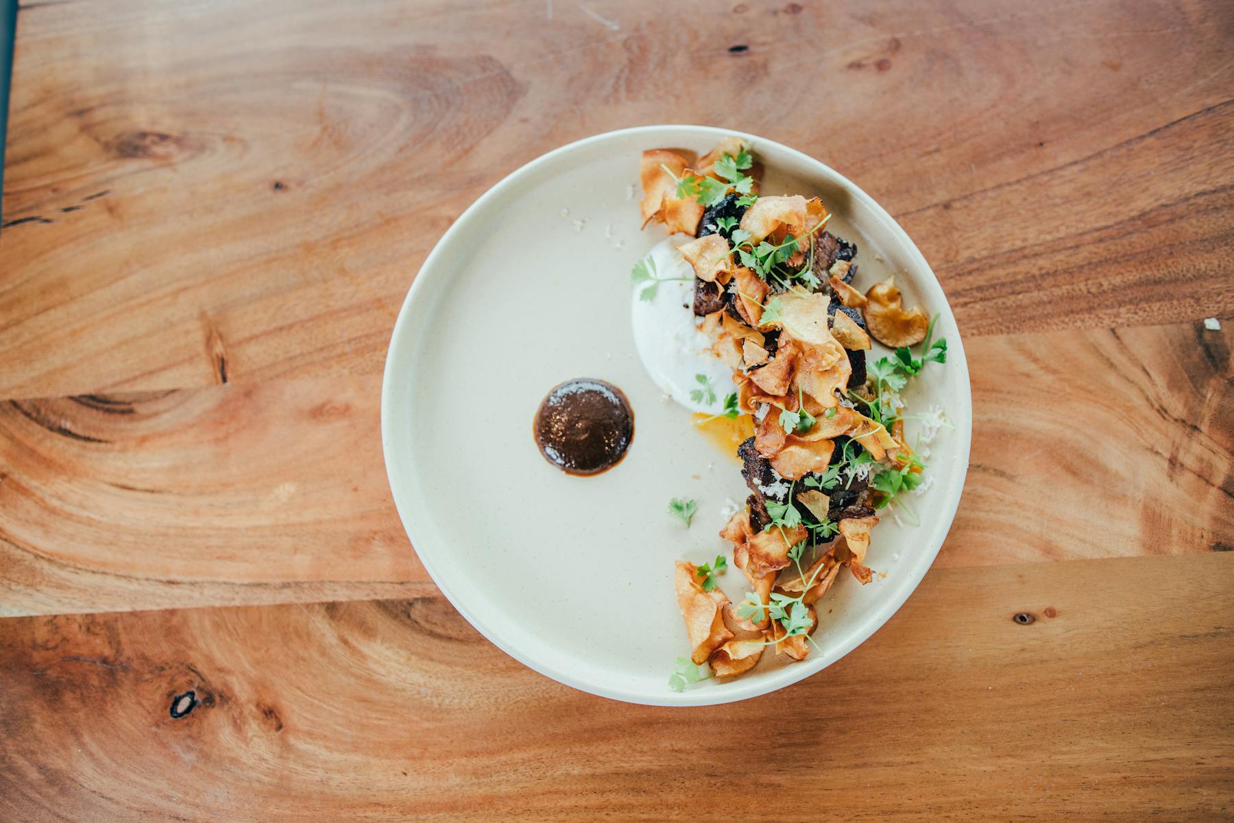 a plate of food sitting on top of a wooden table