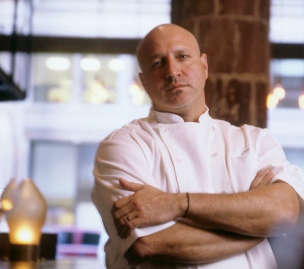 Tom Colicchio sitting on a table