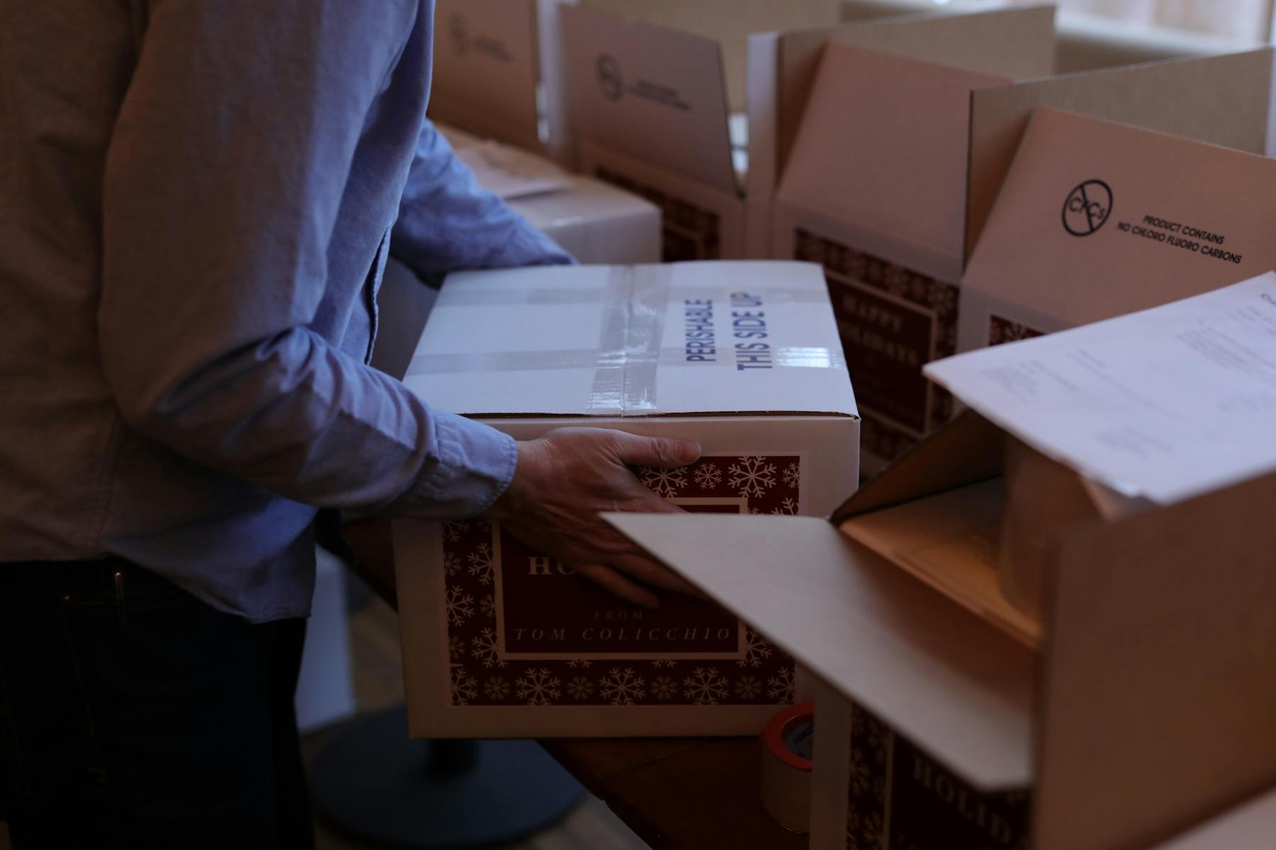 man packing a box