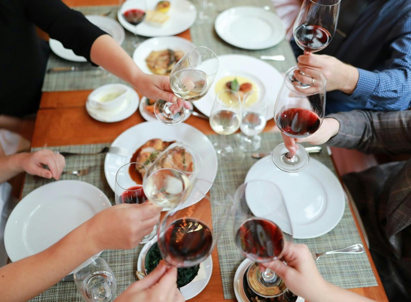 a group of people sitting at a table with wine glasses
