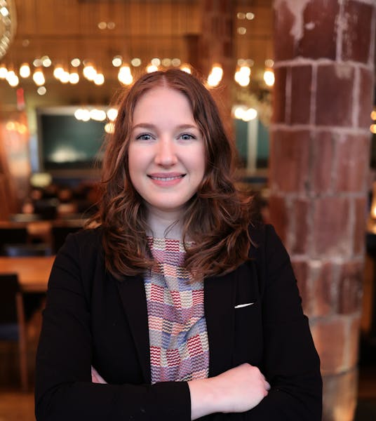 a woman sitting at a table in a restaurant