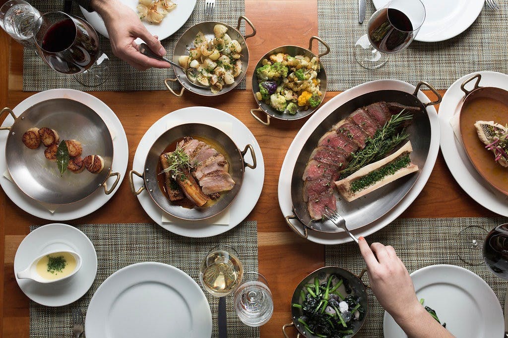 multiple plates of food on a table