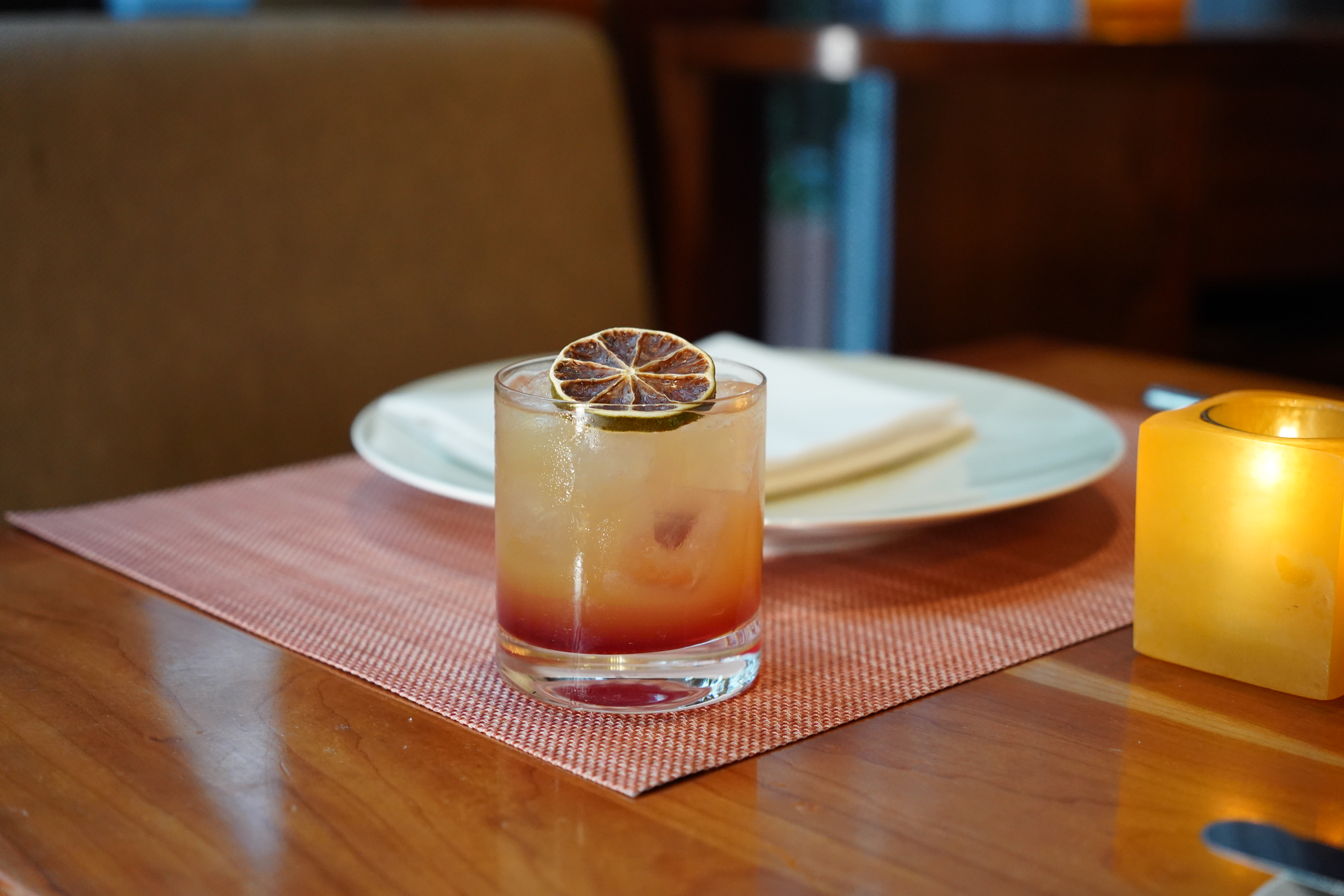 a cup of coffee sitting on top of a wooden table