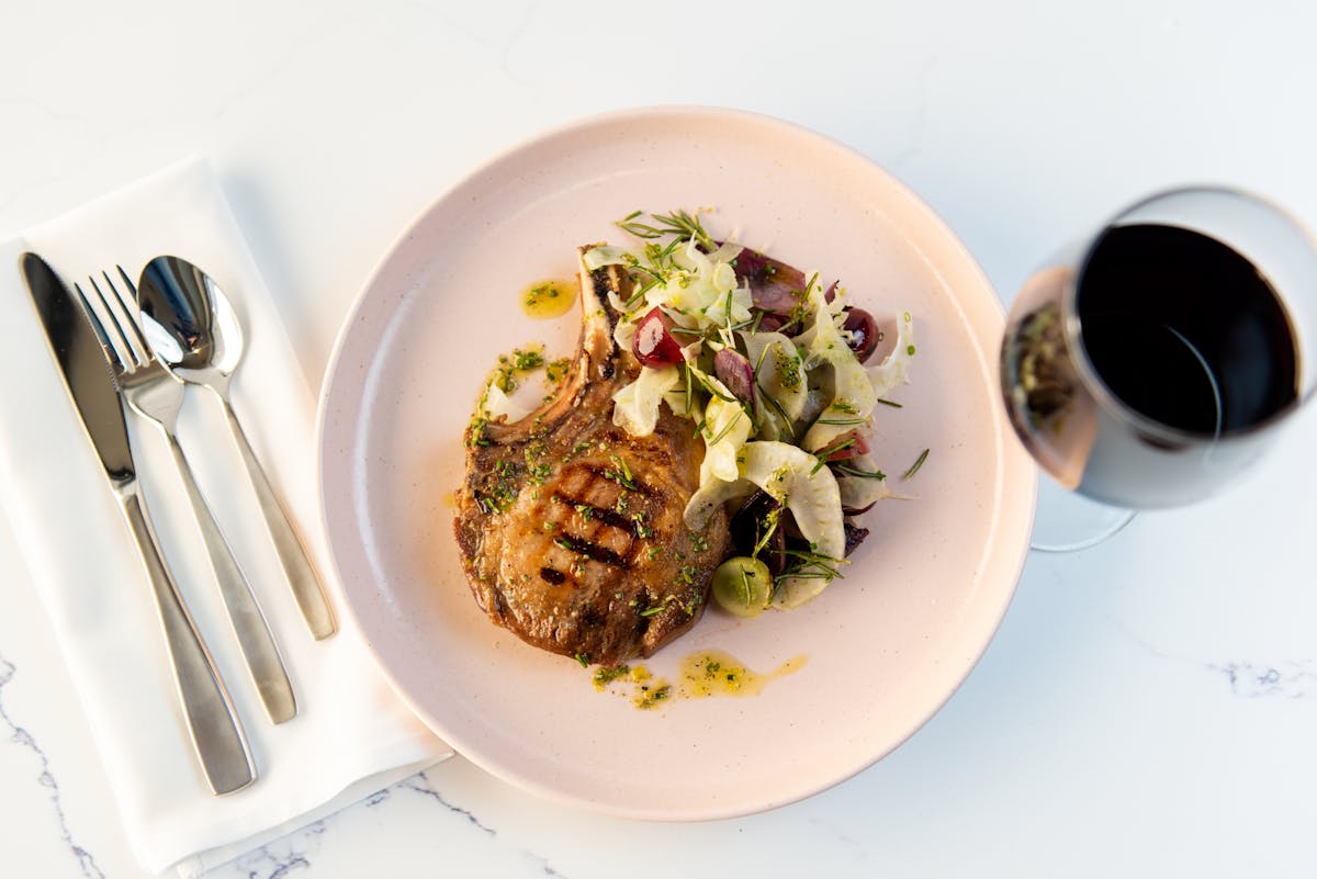 a plate of food and a spoon on a table