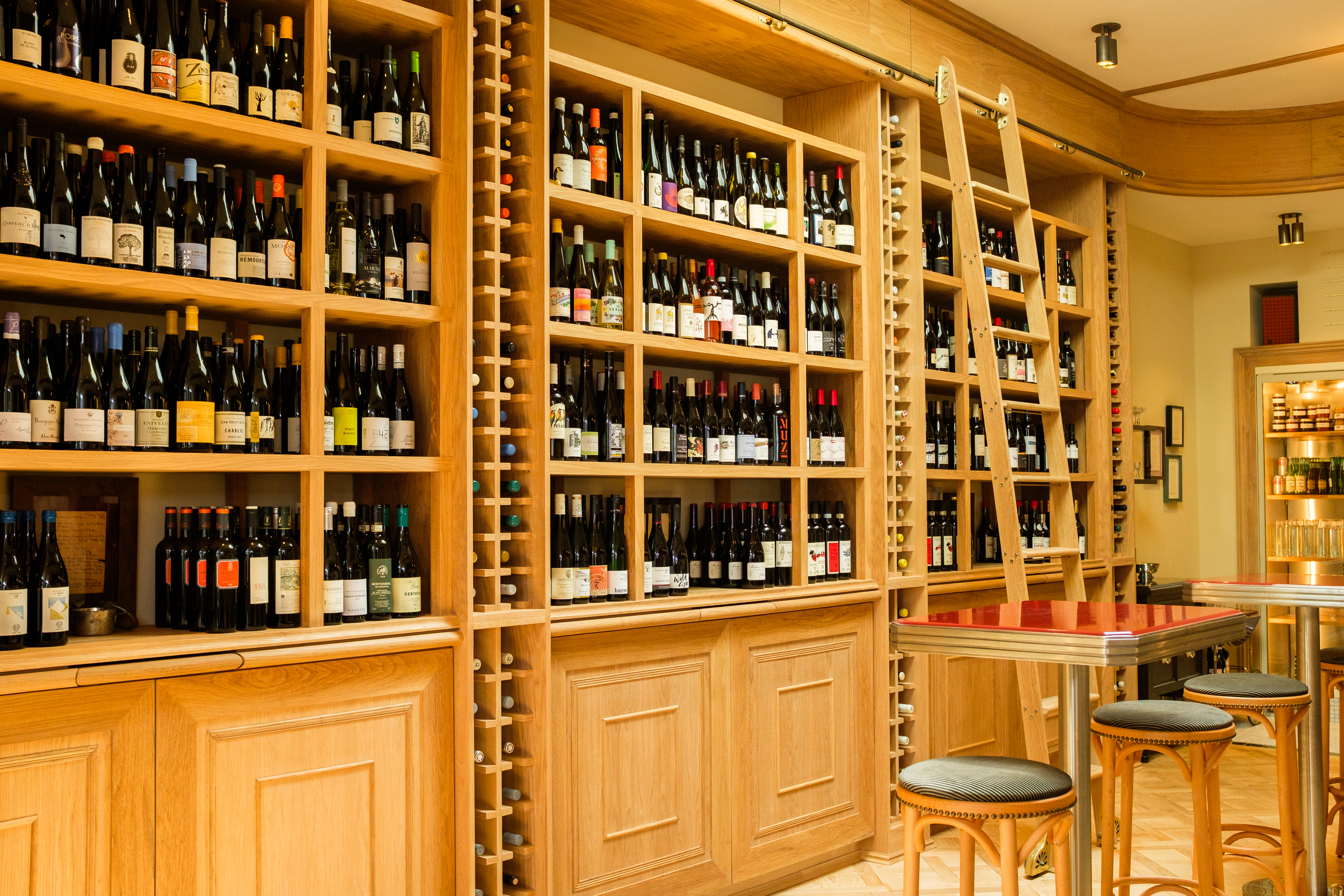 a wine cellar with shelves of wine bottles