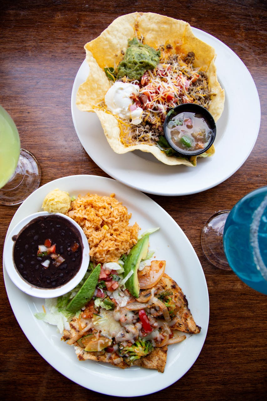 Two plates of traditional mexican food