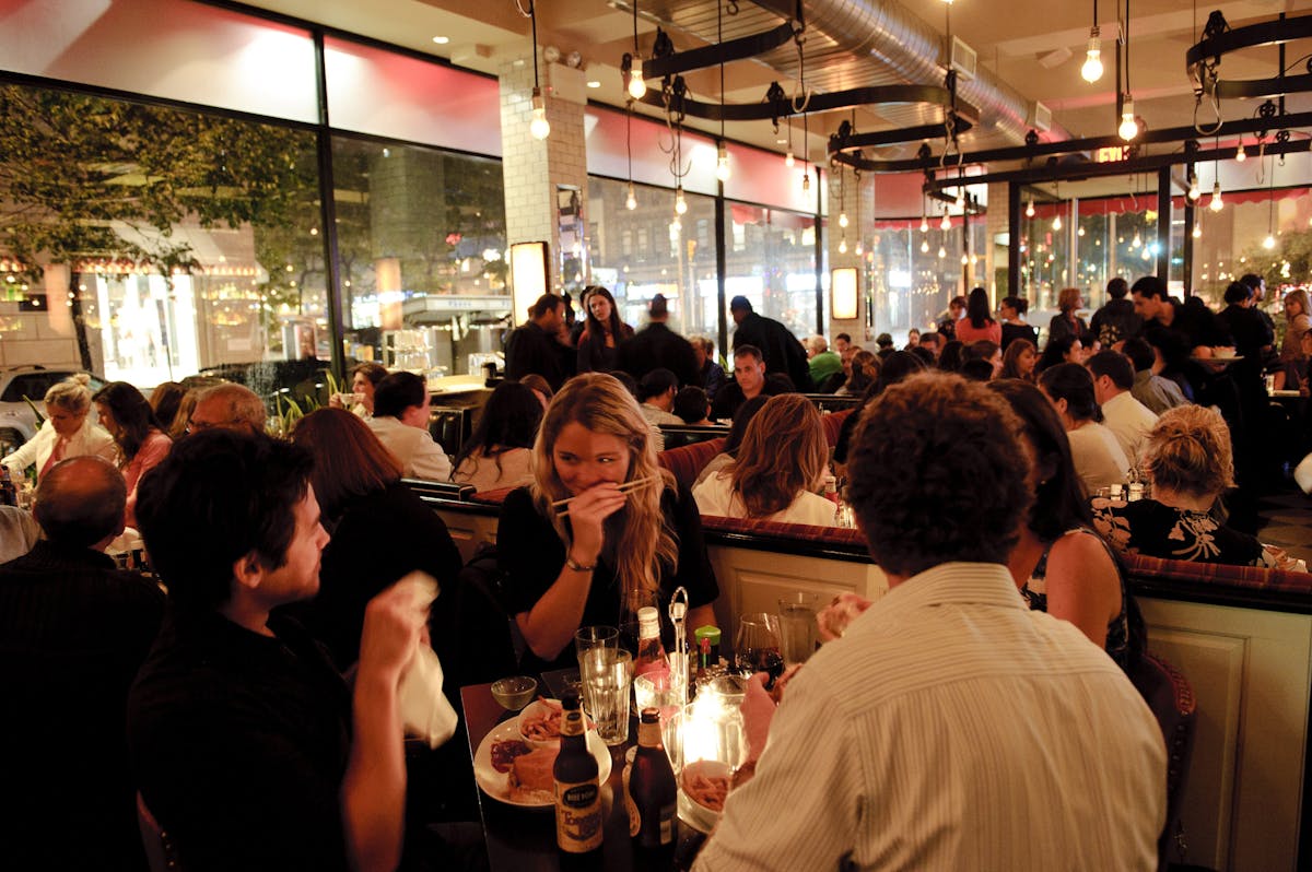 a group of people sitting at a table with wine glasses